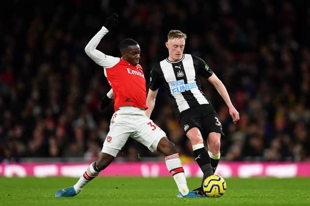 LONDON, ENGLAND - FEBRUARY 16: Edward Nketiah of Arsenal tackles Sean Longstaff of Newcastle United during the Premier League match between Arsenal FC and Newcastle United at Emirates Stadium on February 16, 2020 in London, United Kingdom. (Photo by Justin Setterfield/Getty Images)