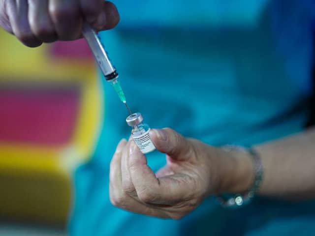 A doctor draws up the Pfizer-BioNTech vaccine at a pop-up vaccination centre. Picture: Ian Forsyth/Getty Images.