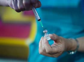 A doctor draws up the Pfizer-BioNTech vaccine at a pop-up vaccination centre. Picture: Ian Forsyth/Getty Images.