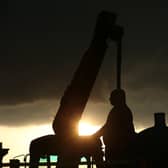 Workers take down a statue of slave owner Robert Milligan at West India Quay, east London as Labour councils across England and Wales will begin reviewing monuments and statues in their towns and cities, after a protest saw anti-racism campaigners tear down a statue of a slave trader in Bristol. Picture by Yui Mok/PA Wire