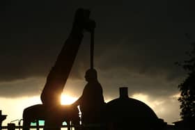 Workers take down a statue of slave owner Robert Milligan at West India Quay, east London as Labour councils across England and Wales will begin reviewing monuments and statues in their towns and cities, after a protest saw anti-racism campaigners tear down a statue of a slave trader in Bristol. Picture by Yui Mok/PA Wire
