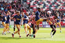 Alexander Isak of Newcastle United fouls Rico Henry of Brentford (Photo by Alex Pantling/Getty Images)