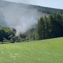 Screen grab from BBC Scotland showing smoke billowing from the train on the track in the countryside near Stonehaven, Aberdeenshire . Emergency services are at the scene after a train derailed in Aberdeenshire.