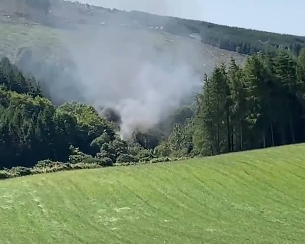 Screen grab from BBC Scotland showing smoke billowing from the train on the track in the countryside near Stonehaven, Aberdeenshire . Emergency services are at the scene after a train derailed in Aberdeenshire.