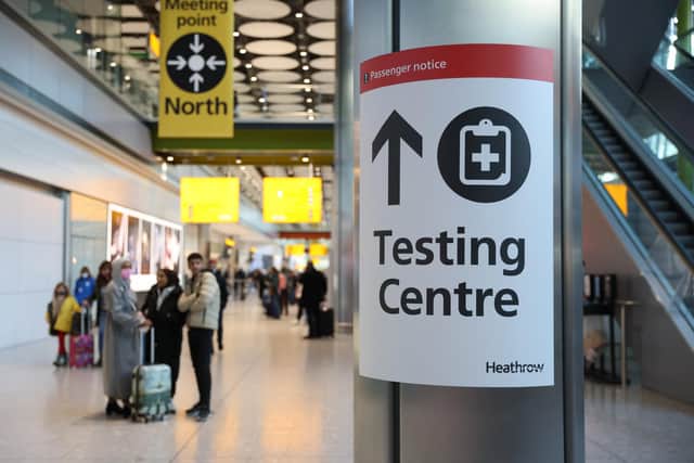 LONDON, ENGLAND - NOVEMBER 28: A covid testing centre sign at Heathrow Terminal 5 on November 28, 2021 in London, England. Following the discovery of a new Covid-19 variant, whose mutations suggest greater transmissibility than previous virus strains, the United Kingdom imposed new restrictions on arriving travelers. From 04:00 today, people arriving from South Africa, Botswana, Lesostho, Eswatini, Zimbabwe and Namibi, Malawi, Mozambique, Zambia, and Angola will face mandatory hotel quarantine. From Tuesday, all international travelers must isolate until they return a negative PCR test, which must be taken by Day 2. (Photo by Hollie Adams/Getty Images)