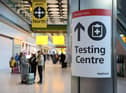 LONDON, ENGLAND - NOVEMBER 28: A covid testing centre sign at Heathrow Terminal 5 on November 28, 2021 in London, England. Following the discovery of a new Covid-19 variant, whose mutations  suggest greater transmissibility than previous virus strains, the United Kingdom imposed new restrictions on arriving travelers. From 04:00 today, people arriving from South Africa, Botswana, Lesostho, Eswatini, Zimbabwe and Namibi, Malawi, Mozambique, Zambia, and Angola will face mandatory hotel quarantine. From Tuesday, all international travelers must isolate until they return a negative PCR test, which must be taken by Day 2. (Photo by Hollie Adams/Getty Images)