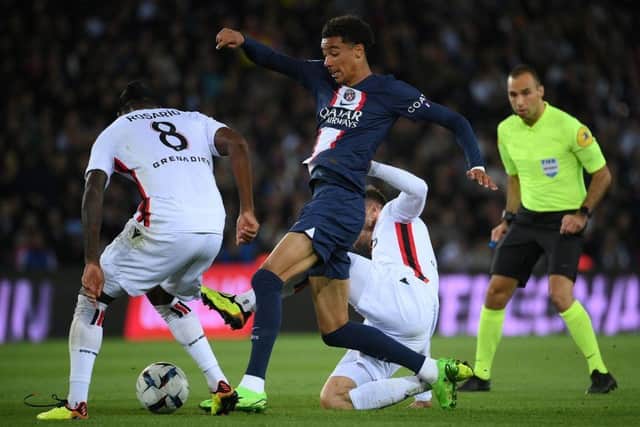 Paris Saint-Germain's French forward Hugo Ekitike (C) and Nice's Dutch midfielder Pablo Rosario fight for the ball during the French L1 football match between Paris Saint-Germain (PSG) and OGC Nice at The Parc des Princes Stadium in Paris on October 1, 2022. (Photo by FRANCK FIFE / AFP) (Photo by FRANCK FIFE/AFP via Getty Images)