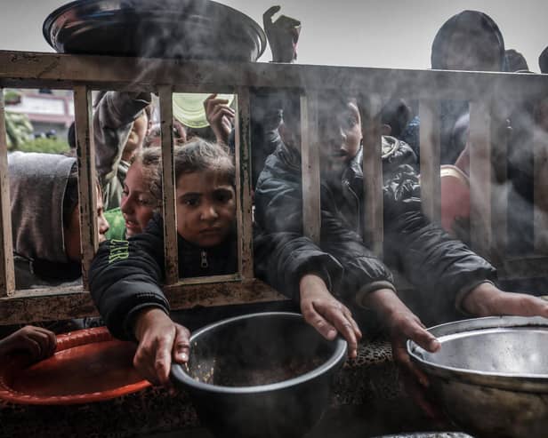 Displaced Palestinian children gather to receive food at a government school in Rafah in the southern Gaza Strip (Picture: Mohammed Abed/AFP via Getty Images)