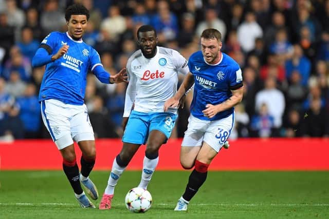 Napoli's French midfielder Tanguy Ndombele (C) vies for the ball with Rangers' German-born US midfielder Malik Tillman (L) and Rangers' Scottish defender Leon King (R) during the UEFA Champions League Group A football match between Scotland's Rangers and Italy's Napoli at Ibrox stadium in Glasgow, on September 14, 2022.(Photo by ANDY BUCHANAN/AFP via Getty Images)