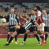 Newcastle United's English striker Andy Carroll (C) clears the ball from his own penalty area during the English FA Cup third round football match between Arsenal and Newcastle United at the Emirates Stadium in London on January 9, 2021.