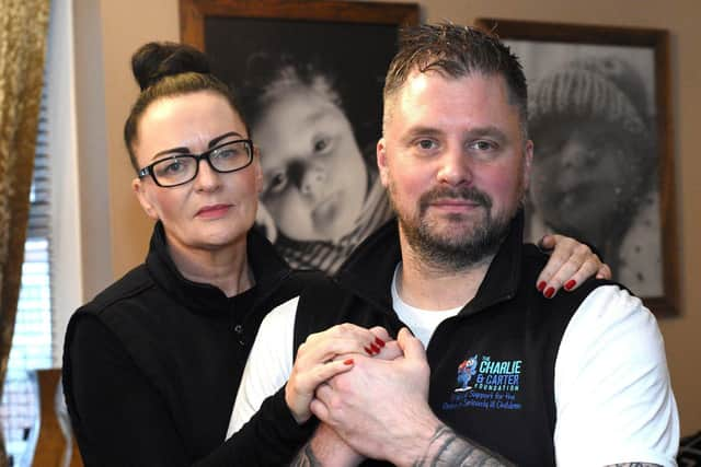 Chris Cookson awarded an MBE for his charity work through him and his wife Sarah's "Charlie and Carter Foundation" pictured in front of treasured photos of their beloved sons.