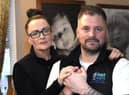 Chris Cookson awarded an MBE for his charity work through him and his wife Sarah's "Charlie and Carter Foundation" pictured in front of treasured photos of their beloved sons.