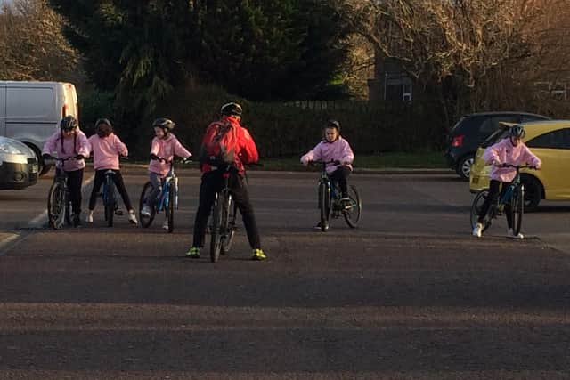 On their bikes.