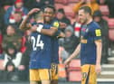 Joe Willock celebrates with Miguel Almiron of Newcastle United after scoring their team's third goal during the Premier League match between Southampton FC and Newcastle United at Friends Provident St. Mary's Stadium on November 06, 2022 in Southampton, England. (Photo by Charlie Crowhurst/Getty Images)
