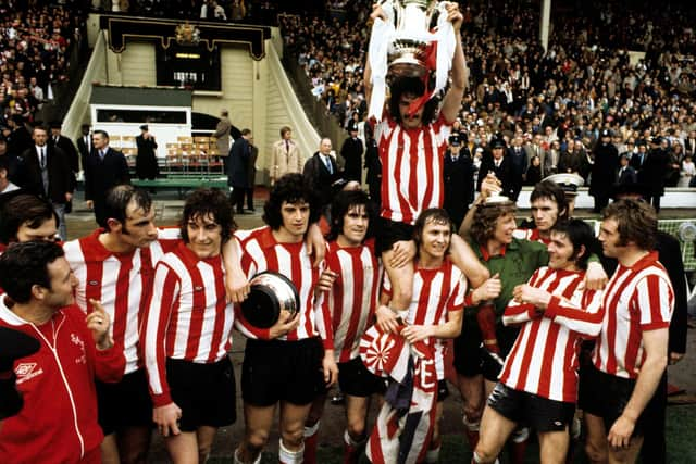 Bobby Kerr is held aloft by teammates