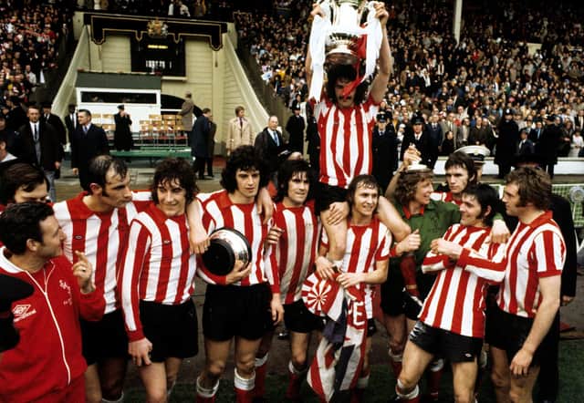 Bobby Kerr is held aloft by teammates