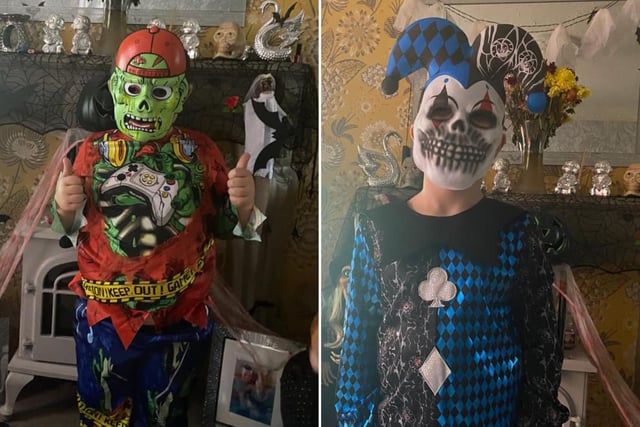 Thumbs up for Halloween! Alex age 6, left, and Owen, age 7, show off their scary outfits.