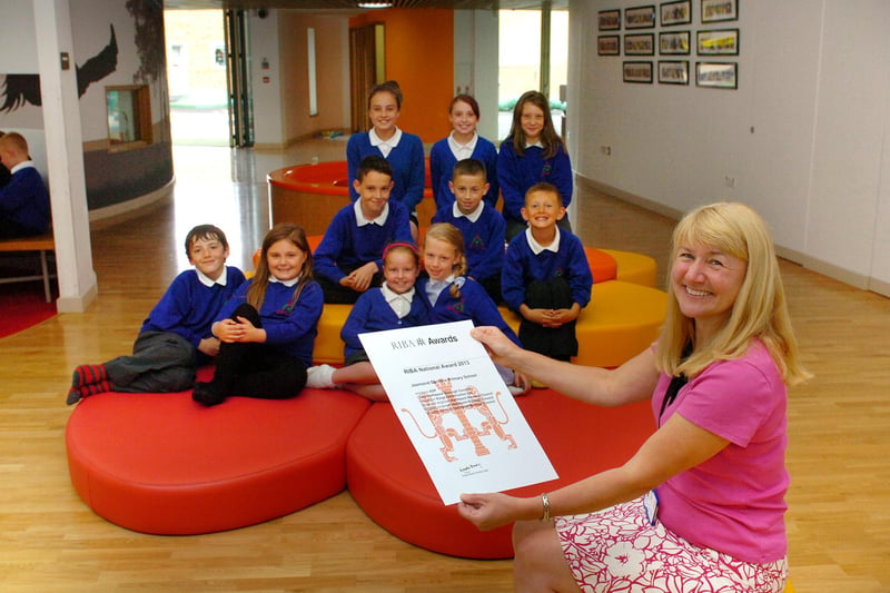 Head teacher Jane Loomes celebrates with some of her pupils at Jesmond Gardens Primary School, which won three major architectural awards in 2013.