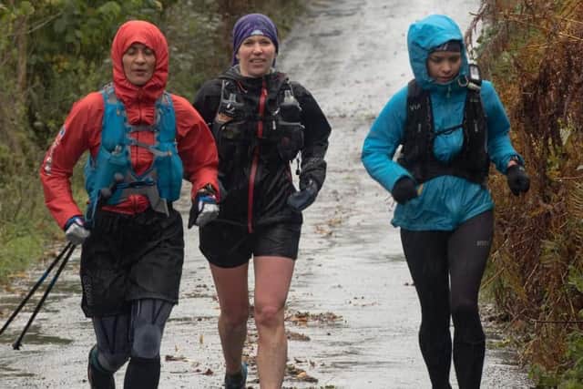 Sarah Perry (right) running through the Lake District with some of her support team.
Photograph: Ian Burns