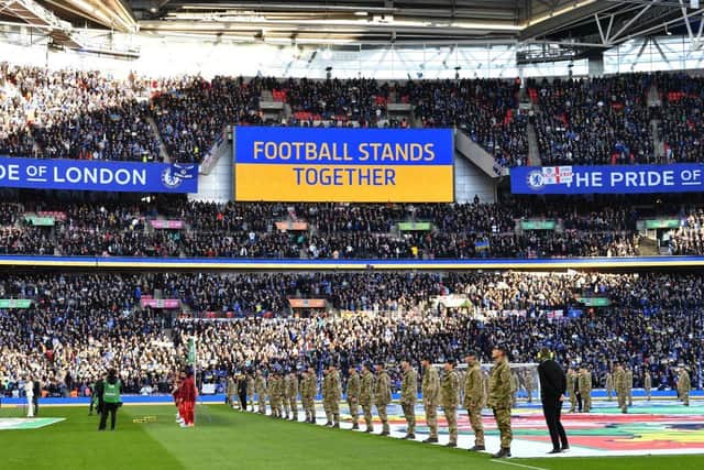 A 'Football Stands Together' message is displayed in Ukrainian colours ahead of the English League Cup final football match between Chelsea and Liverpool at Wembley Stadium, north-west London on February 27, 2022.(Photo by JUSTIN TALLIS/AFP via Getty Images)