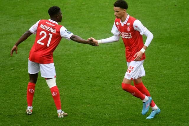 Reims' forward Hugo Ekitike (R) celebrates with his teamates Reim's Dutch midfielder Azor Matusiwa scoring his team's first goal during the French L1 football match Reims and Bordeaux at the Auguste Delaune Stadium in Reims on February 6, 2022. (Photo by FRANCOIS LO PRESTI / AFP) (Photo by FRANCOIS LO PRESTI/AFP via Getty Images)
