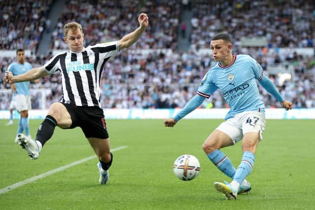 Emil Krafth of Newcastle United challenges Phil Foden of Manchester City during the Premier League match between Newcastle United and Manchester City at St. James Park on August 21, 2022 in Newcastle upon Tyne, England. (Photo by Clive Brunskill/Getty Images)