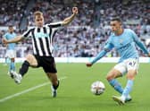 Emil Krafth of Newcastle United challenges Phil Foden of Manchester City during the Premier League match between Newcastle United and Manchester City at St. James Park on August 21, 2022 in Newcastle upon Tyne, England. (Photo by Clive Brunskill/Getty Images)