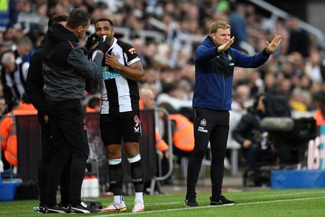 Newcastle United's English head coach Eddie Howe (R) gives his team instructions as Newcastle United's English striker Callum Wilson receives treatment during the English Premier League football match between Newcastle United and Arsenal at St James' Park in Newcastle-upon-Tyne, north east England on May 16, 2022. (Photo by OLI SCARFF/AFP via Getty Images)