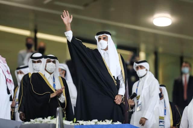 Qatar's Emir Sheikh Tamim bin Hamad al-Thani (C), clad in mask as part of COVID-19 coronavirus pandemic protocols, waves during the Amir Cup final football match between al-Sadd and al-Arabi at Al-Rayyan Stadium in Al-Rayyan, Qatar, on December 18, 2020. (Photo by KARIM JAAFAR / AFP) (Photo by KARIM JAAFAR/AFP via Getty Images)