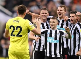 Nick Pope of Newcastle United joins in with the celebrations as team mates Sven Botman, Kieran Trippier, Dan Burn and Fabian Schar celebrates their side's win after the final whistle of the Premier League match between Newcastle United and Everton FC at St. James Park on October 19, 2022 in Newcastle upon Tyne, England. (Photo by George Wood/Getty Images)