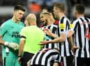 Newcastle United goalkeeper Nick Pope argues with referee Anthony Taylor following his dismissal.