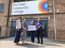 Joanne Thornton, Deputy Head Teacher, and Holly Cooper, Senior Lead Practitioner, presented the Cancer Research UK volunteers, John and Hazel Pickering, with the cheque for almost £3,000.