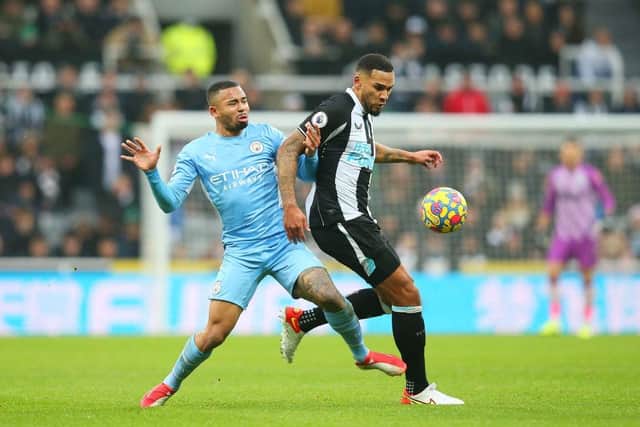 Jamaal Lascelles of Newcastle United is challenged by Gabriel Jesus of Manchester City during the Premier League match between Newcastle United and Manchester City at St. James Park on December 19, 2021 in Newcastle upon Tyne, England. (Photo by Alex Livesey/Getty Images)