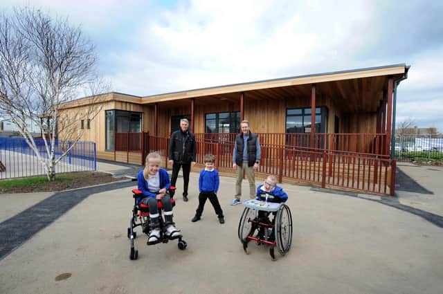 Headteacher Peter Nord, occupational therapist Darren Carr and pupils.