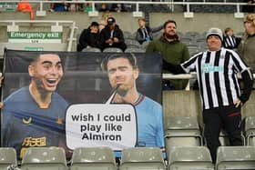 A Newcastle United fan poses for a photo with their flag showing support for Miguel Almiron prior to the Premier League match between Newcastle United and Chelsea FC at St. James Park on November 12, 2022 in Newcastle upon Tyne, England. (Photo by Stu Forster/Getty Images)