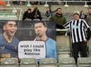 A Newcastle United fan poses for a photo with their flag showing support for Miguel Almiron prior to the Premier League match between Newcastle United and Chelsea FC at St. James Park on November 12, 2022 in Newcastle upon Tyne, England. (Photo by Stu Forster/Getty Images)