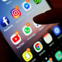 Social media apps displayed on a mobile phone screen. PIC: Yui Mok/PA Wire