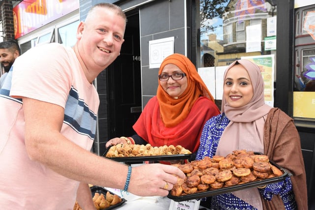 Stephen Mitchell from Scotland is offered the finest food by Iva Rahman and Lina Shafi during his visit to South Shields.