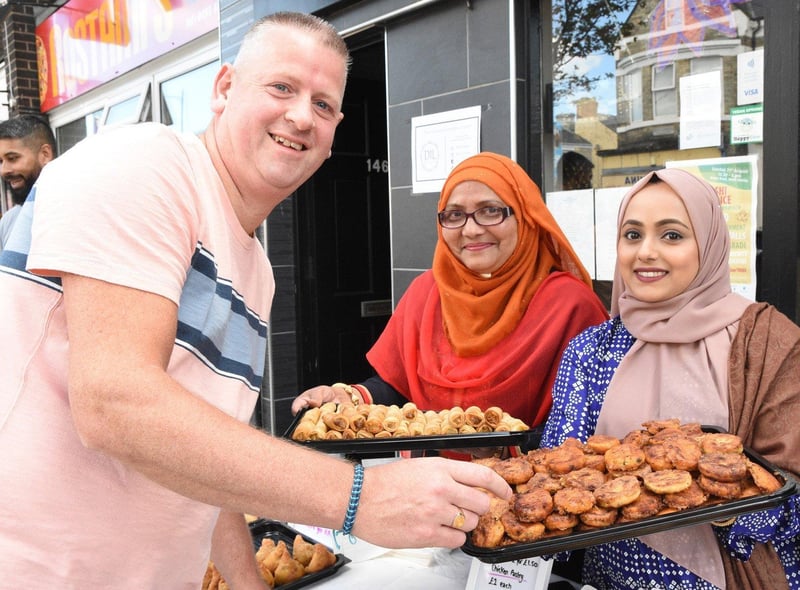 Stephen Mitchell from Scotland is offered the finest food by Iva Rahman and Lina Shafi during his visit to South Shields.
