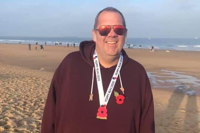 Wayne pictured at the end of his Poppy Run last year when he managed 5k.