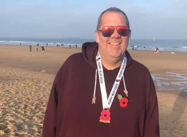 Wayne pictured at the end of his Poppy Run last year when he managed 5k.