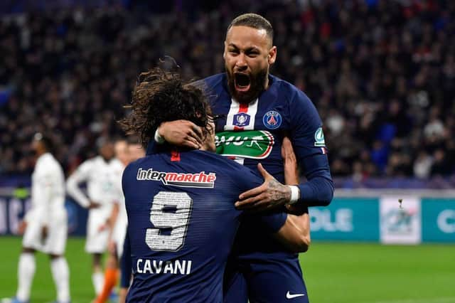 Paris Saint-Germain's Brazilian forward Neymar (R) celebrates with Paris Saint-Germain's Uruguayan forward Edinson Cavani after scoring a penalty kick during the French Cup semi-final football match between Olympique Lyonnais (OL) and Paris Saint-Germain (PSG).