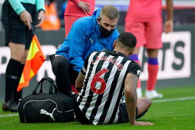 Jamaal Lascelles receives medical attention against Chelsea.