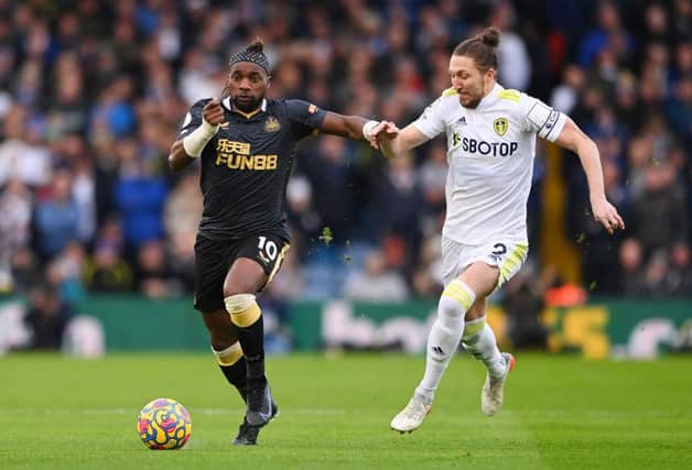 Allan Saint-Maximin of Newcastle United is challenged by Luke Ayling of Leeds United during the Premier League match between Leeds United and Newcastle United at Elland Road on January 22, 2022 in Leeds, England. (Photo by Stu Forster/Getty Images)