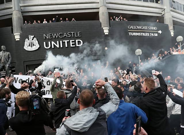Newcastle United supporters celebrate outside the club's stadium St James' Park in Newcastle upon Tyne in northeast England on October 7, 2021, after the sale of the football club to a Saudi-led consortium was confirmed. (Photo by - / AFP) (Photo by -/AFP via Getty Images)