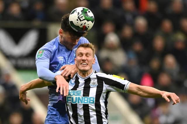 Bournemouth's Kieffer Moore battles for the ball with Newcastle United's Dan Burn.