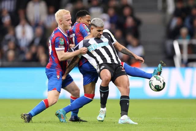 Bruno Guimaraes of Newcastle United is challenged by Will Hughes and  Nathaniel Clyne of Crystal Palace during the Carabao Cup Third Round match between Newcastle United and Crystal Palace at St James' Park on November 09, 2022 in Newcastle upon Tyne, England. (Photo by George Wood/Getty Images)