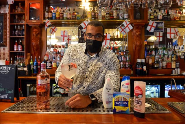 Manager Alex Ozobia at Hogarths, which is running a donation drop for a food bank, with kind-hearted customers taking part to receive a free gin and tonic for World Gin Day.