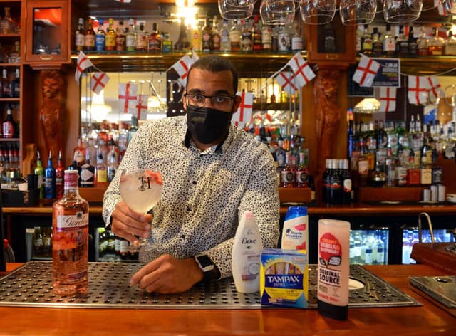 Manager Alex Ozobia at Hogarths, which is running a donation drop for a food bank, with kind-hearted customers taking part to receive a free gin and tonic for World Gin Day.