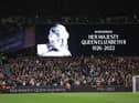 The LED board shows a photo Queen Elizabeth II as players of West Ham United and FCSB observe a minutes silence after it was announced that Queen Elizabeth II has passed away during the UEFA Europa Conference League group B match between West Ham United and FCSB at London Stadium on September 08, 2022 in London, England. (Photo by Richard Heathcote/Getty Images)